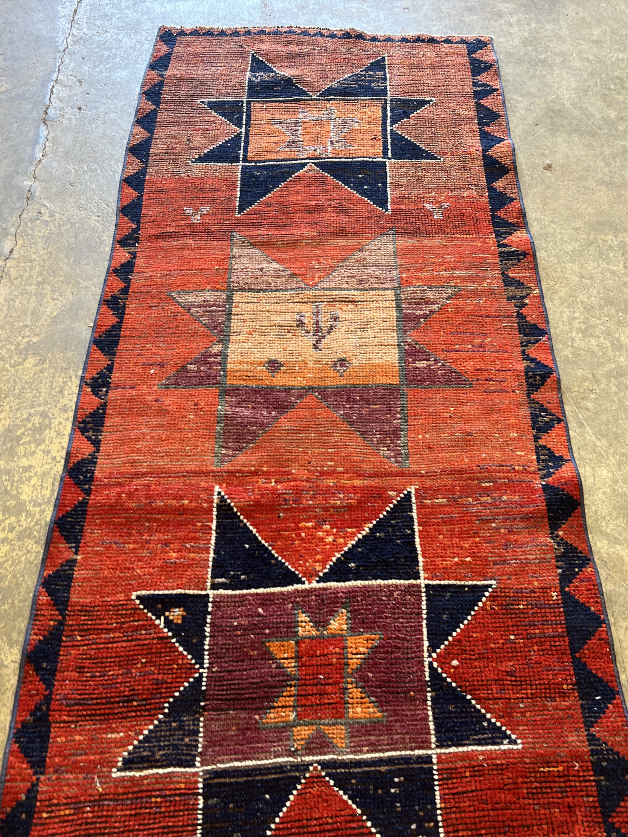 A Turkish red ground geometric runner, 298 x 87cm